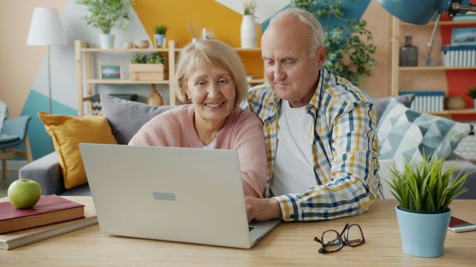 Senior couple using a laptop together