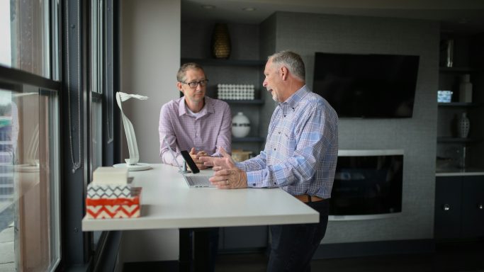 Two senior adults having a conversation at a table